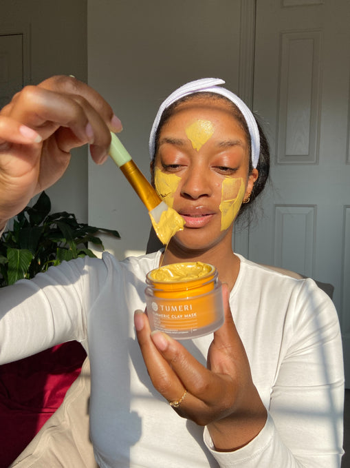 Girl Applying Turmeric Clay Mask