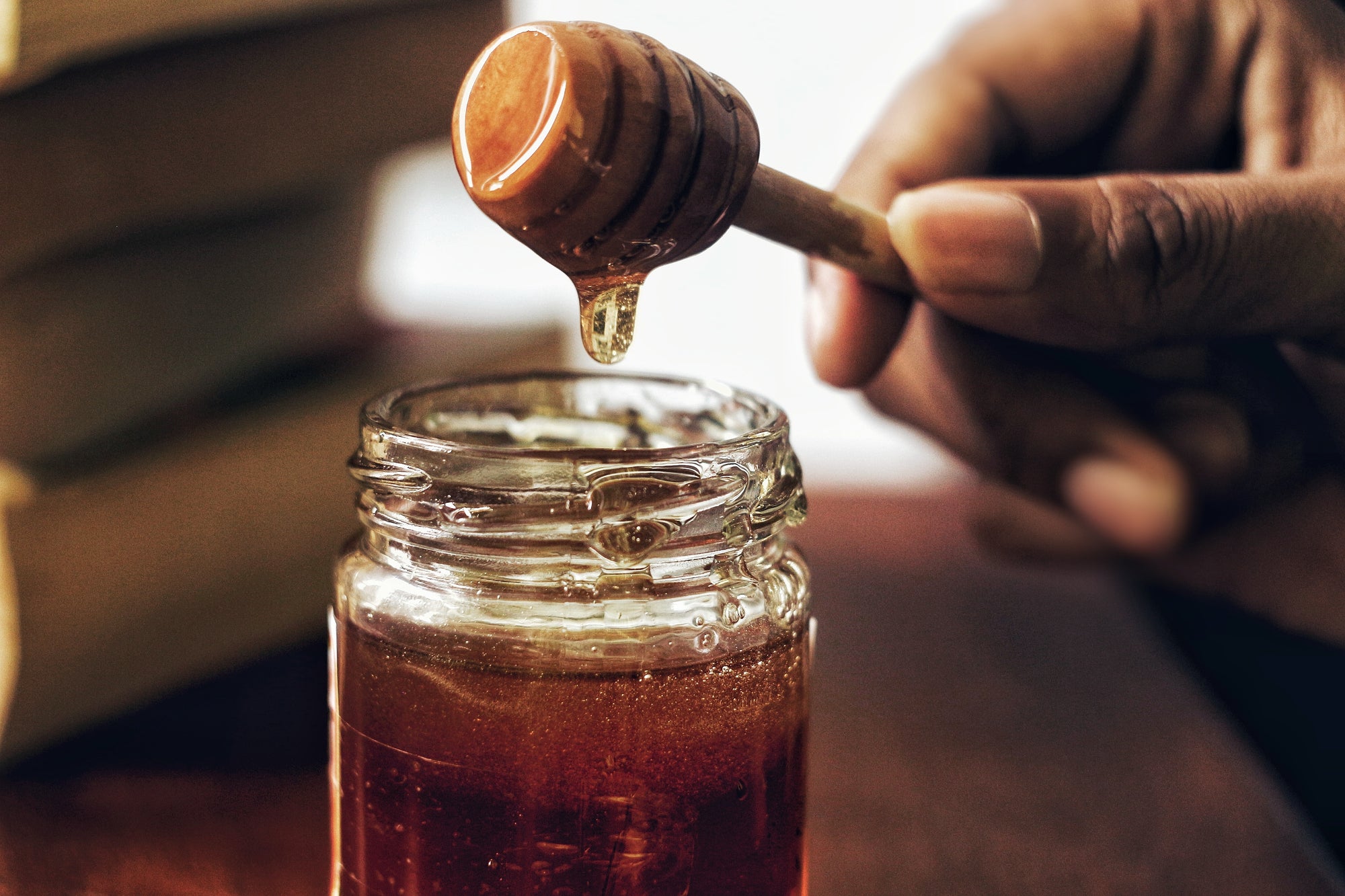 manuka honey bottle with hand